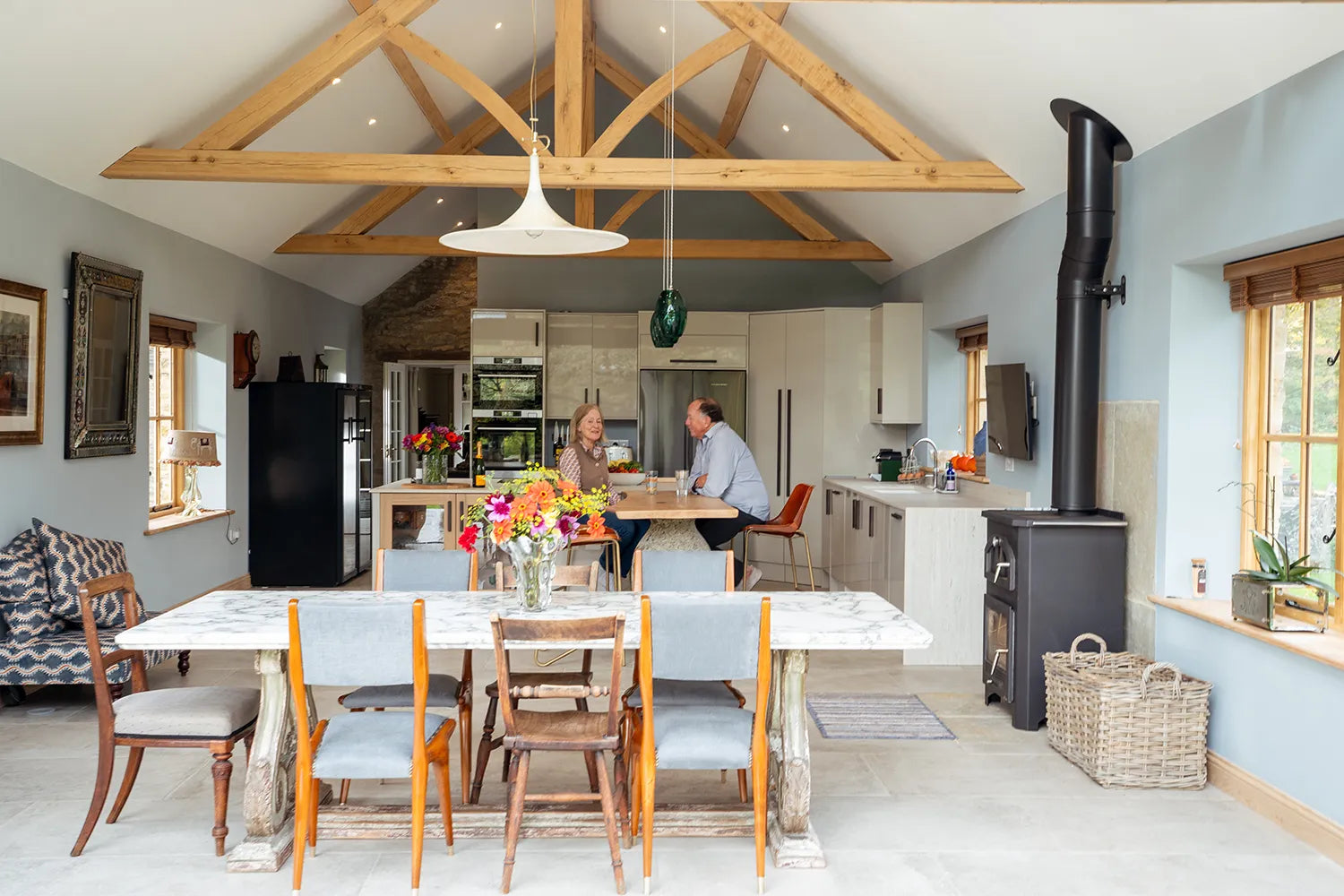 Modern kitchen with wooden beams and a dining area.